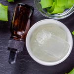 natural aloe vera essential oil on a dark rustic wooden background.
