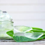 Aloe vera gel on bottle on old wood background.