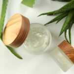 Aloe vera and cosmetics on white background