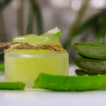 Aloe vera gel and fresh aloe vera leaves.